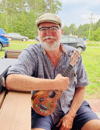 Man posing with decorated ukulele